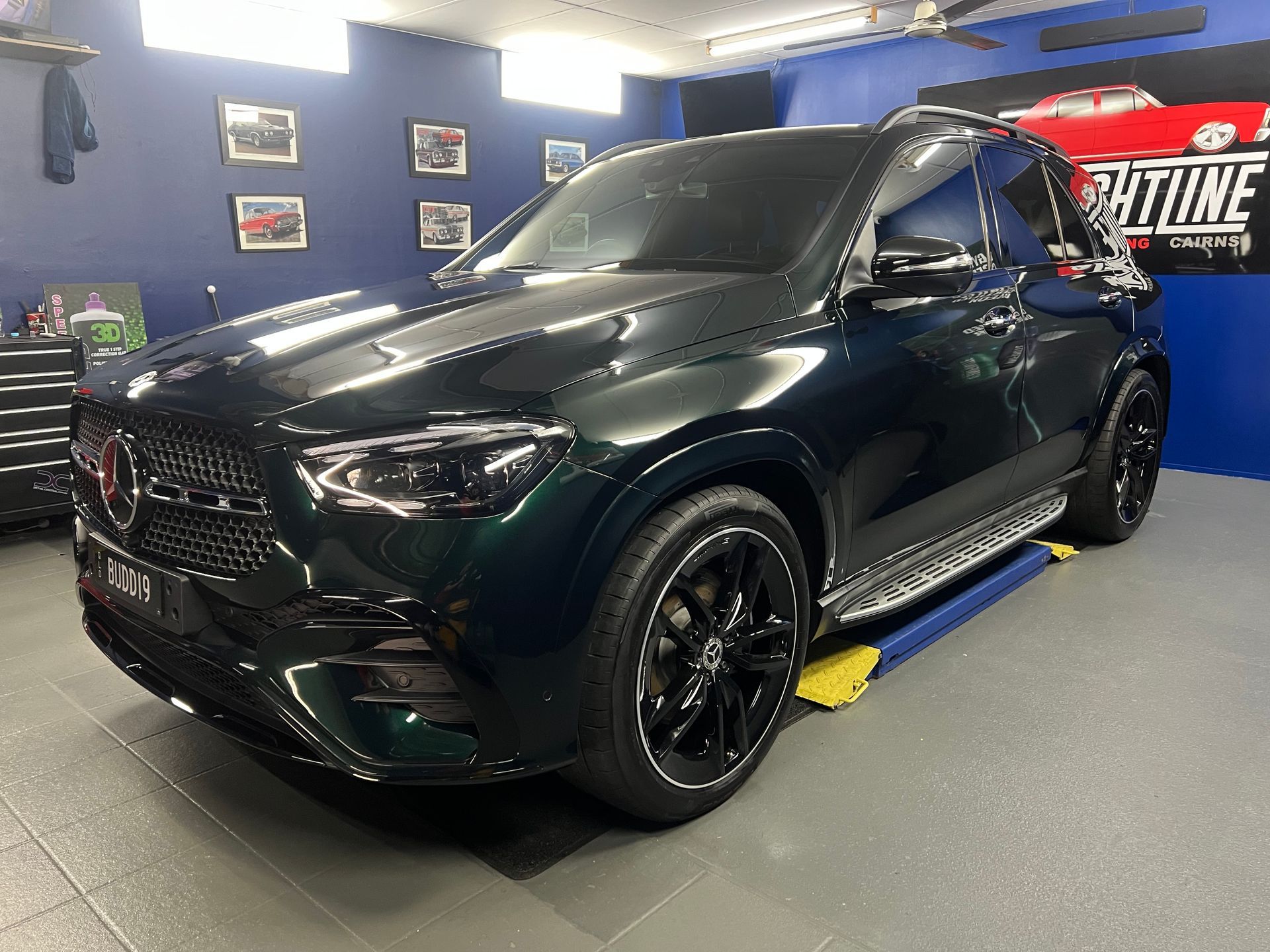 Black SUV on Display in A Showroom with Blue Walls — Straightline Detailing Cairns in Bungalow, QLD