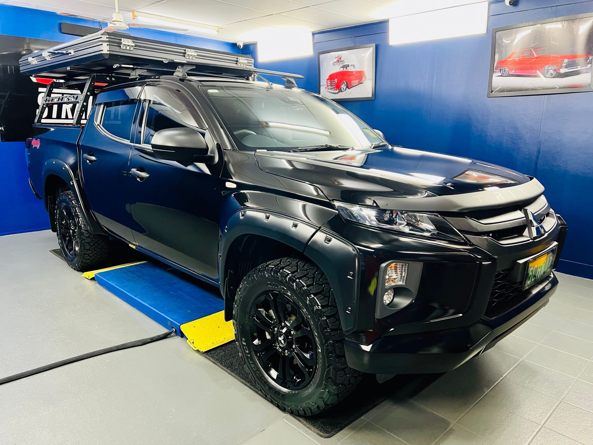 Black SUV In a Blue-Walled Showroom — Straightline Detailing Cairns in Bungalow, QLD