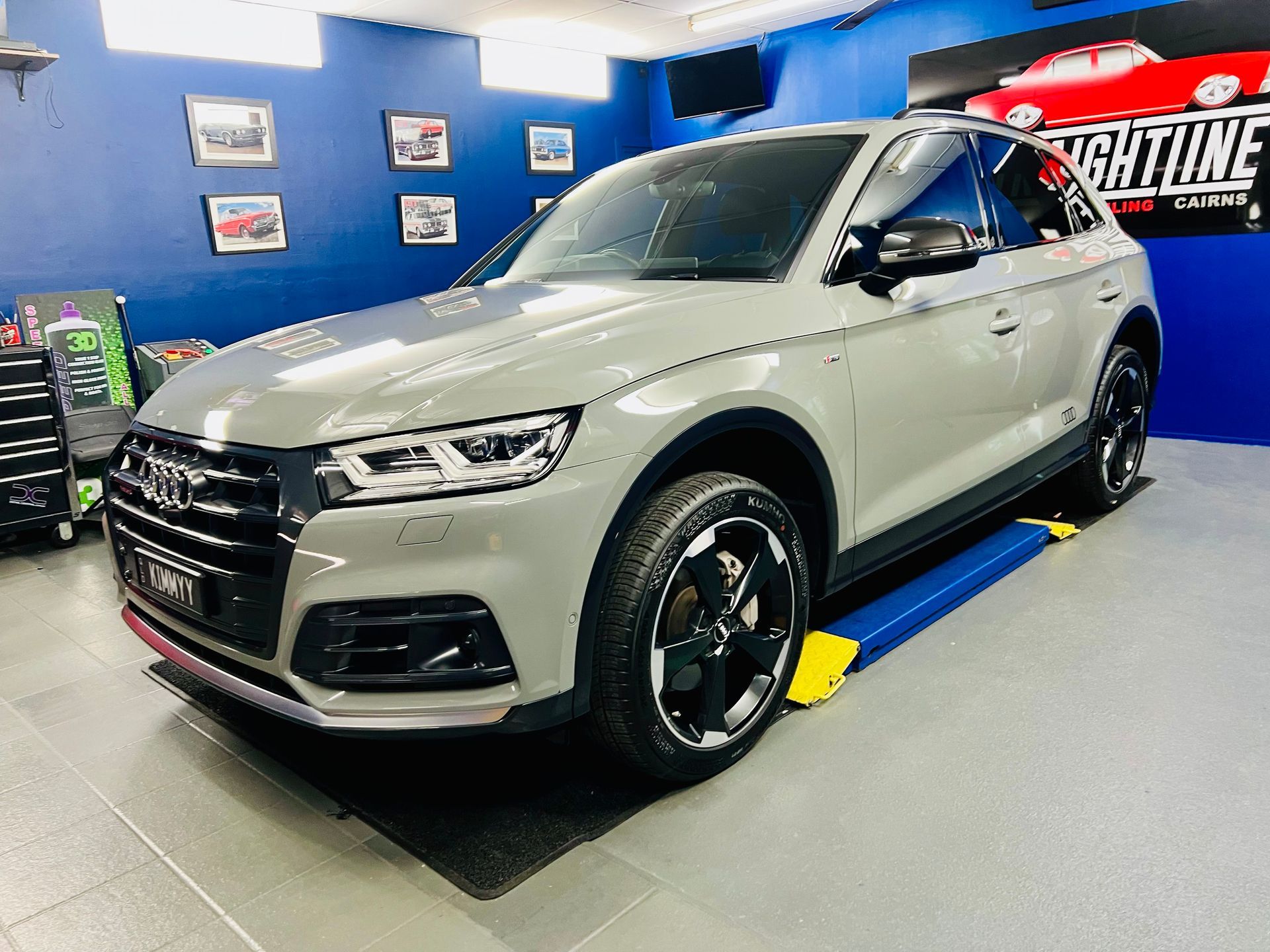Silver SUV On a Showroom Floor with Blue Walls — Straightline Detailing Cairns in Bungalow, QLD