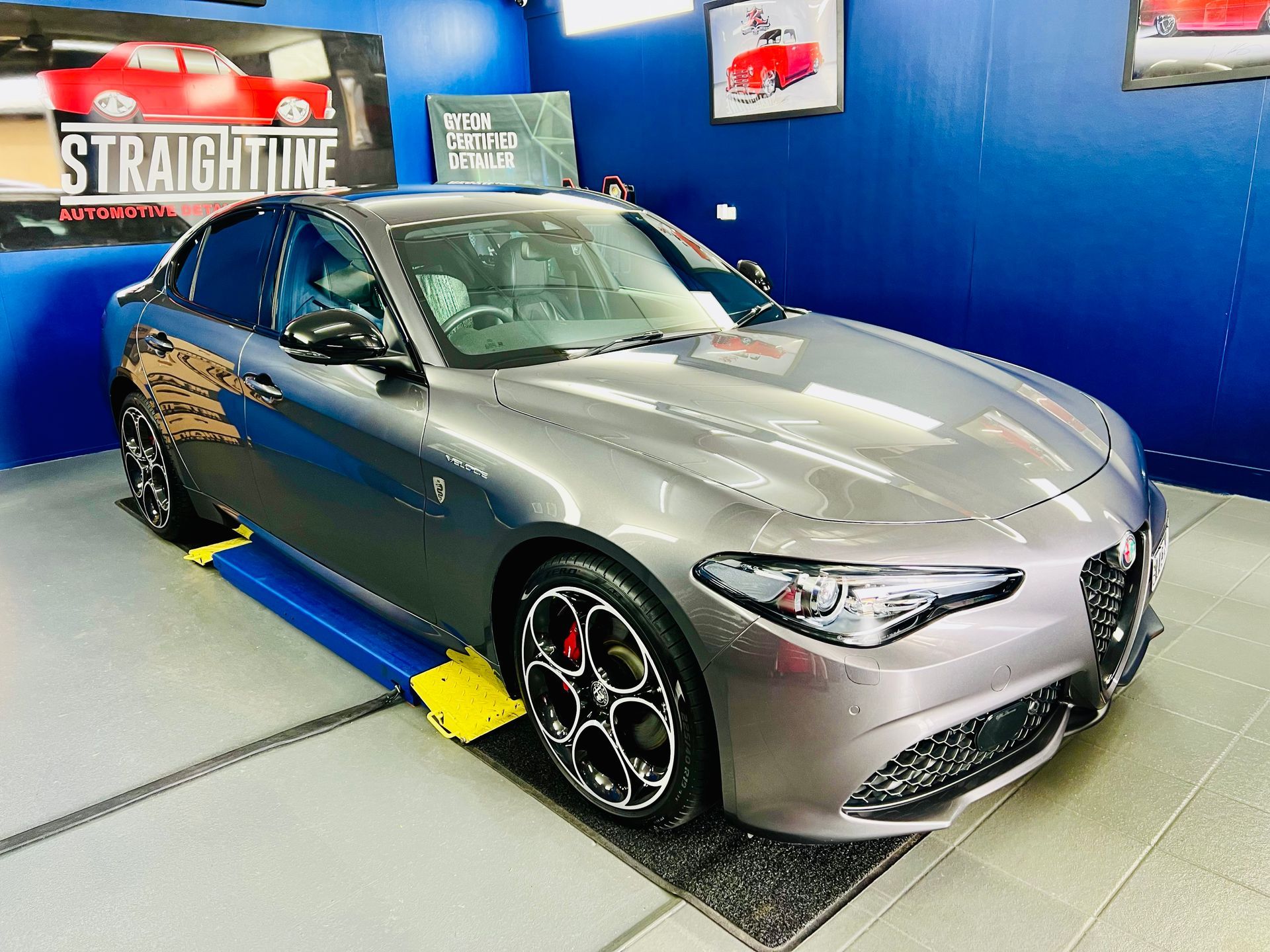 Silver Sports Car on A Blue Platform in A Showroom — Straightline Detailing Cairns in Bungalow, QLD