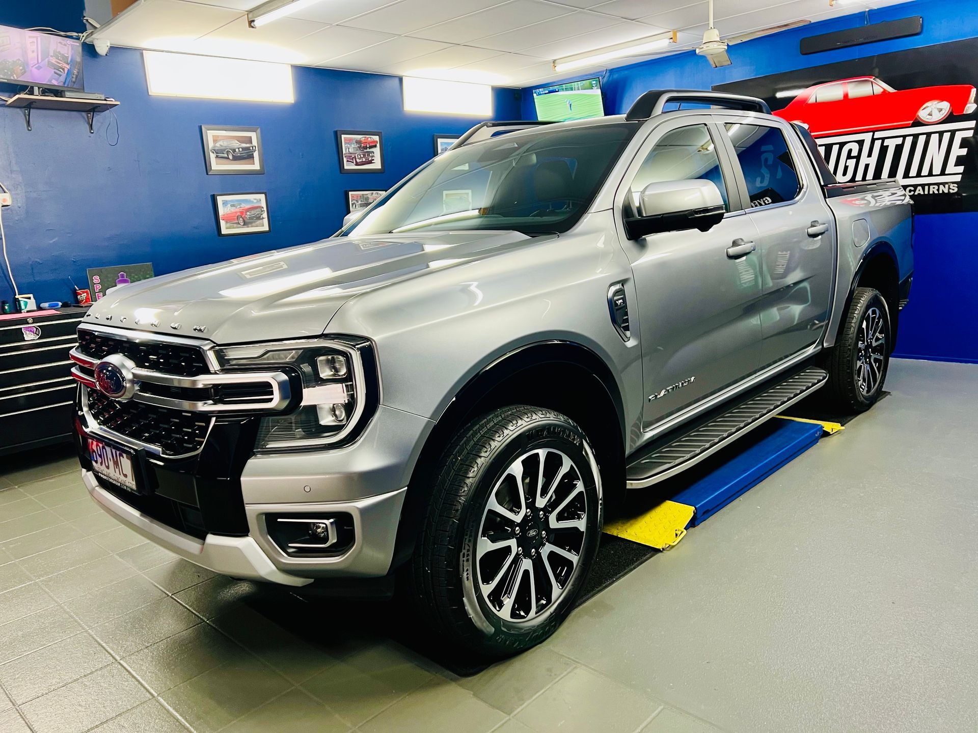 Silver Pickup Truck in A Blue Auto Shop, Parked on A Lift — Straightline Detailing Cairns in Bungalow, QLD