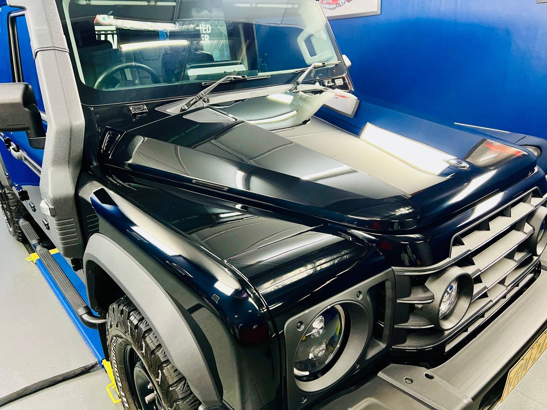 Black Mercedes G-Class Suv in A Blue-Walled Showroom, Front-Left View — Straightline Detailing Cairns in Bungalow, QLD