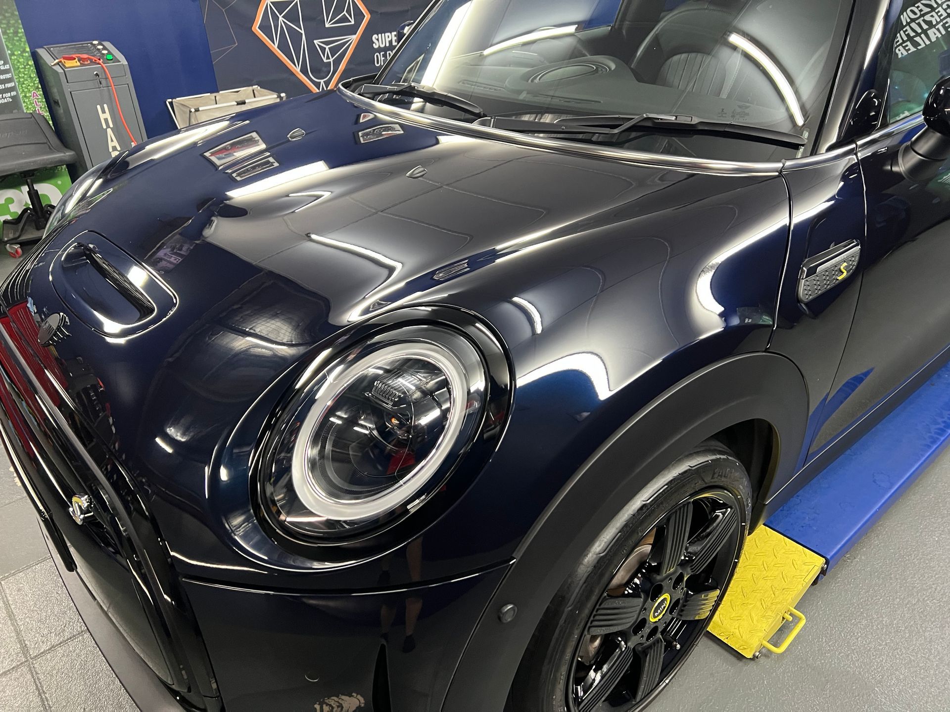 Dark Blue Sports Car on A Blue Platform in A Garage — Straightline Detailing Cairns in Bungalow, QLD