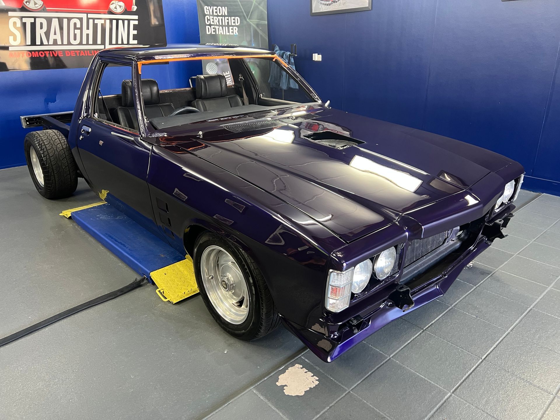 Purple Classic Convertible Car on A Shop Lift in A Garage — Straightline Detailing Cairns in Bungalow, QLD