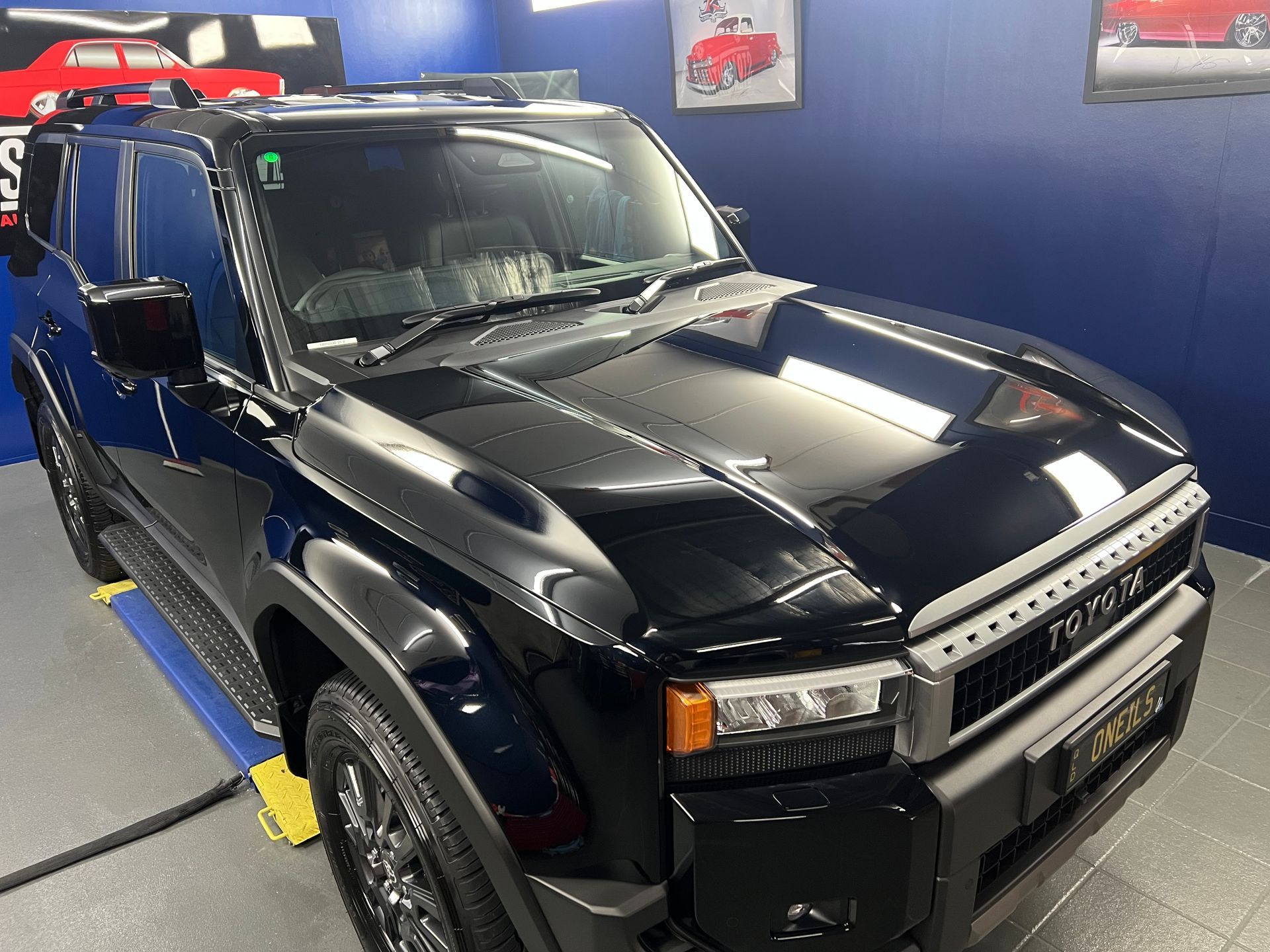Black Hummer SUV On Display in A Showroom, Viewed from The Front-Left — Straightline Detailing Cairns in Bungalow, QLD