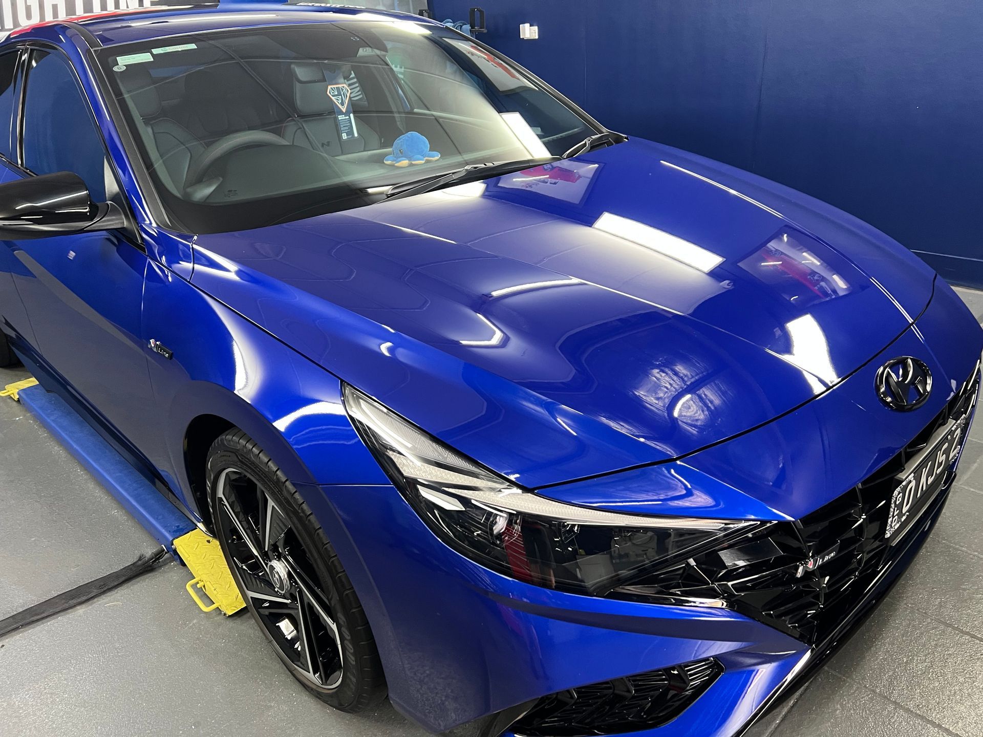 Blue Sports Car Parked Indoors, Angled Front View — Straightline Detailing Cairns in Bungalow, QLD