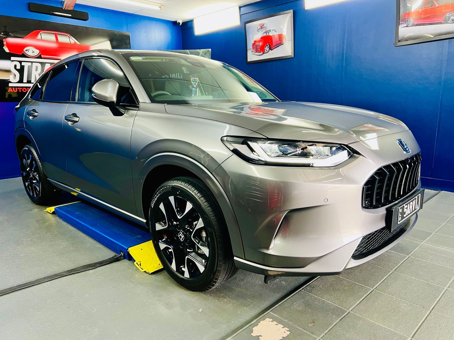 Silver SUV On a Display Platform in A Blue Showroom — Straightline Detailing Cairns in Bungalow, QLD