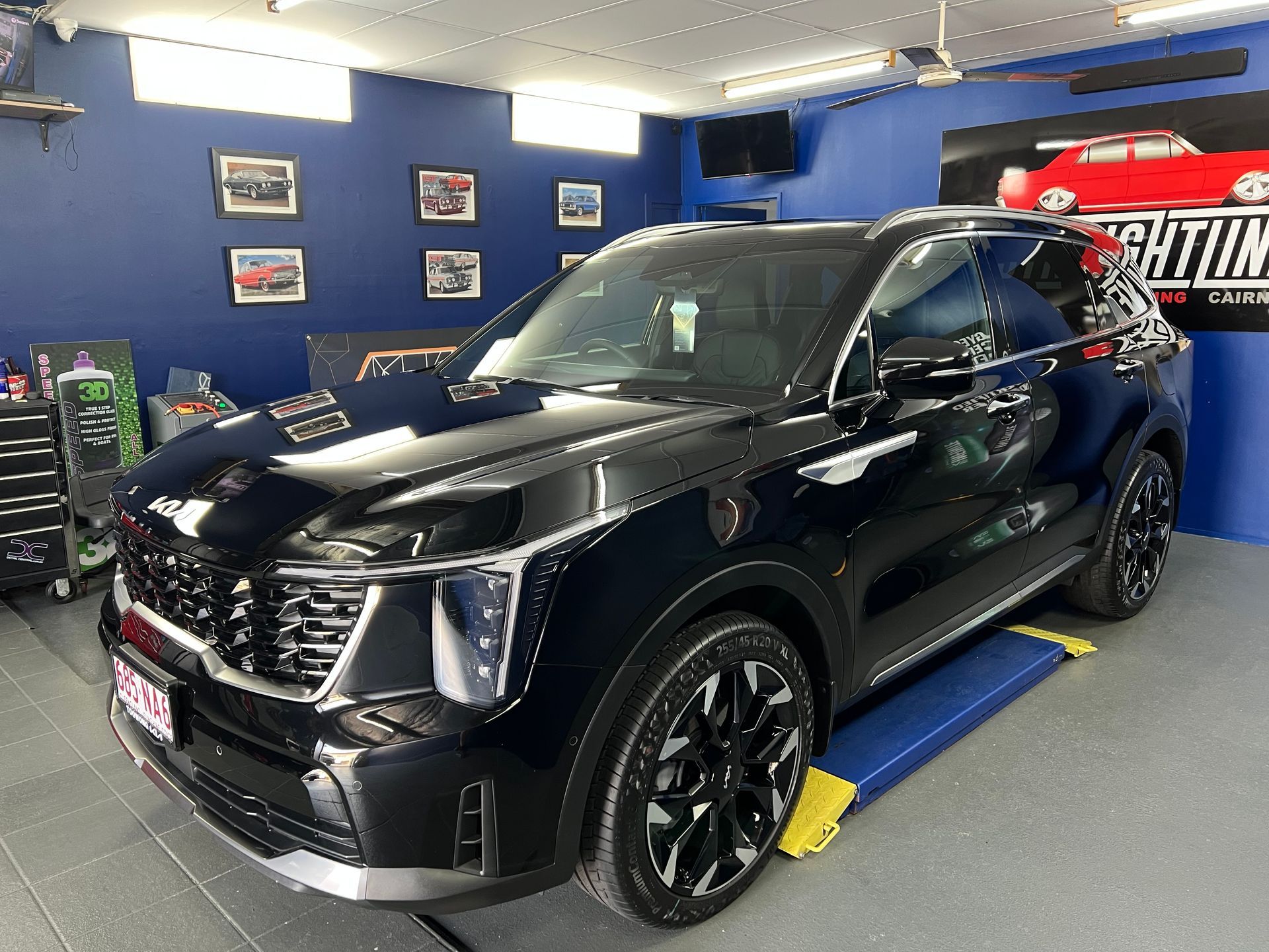 Black Cadillac SUV In a Blue Auto Showroom — Straightline Detailing Cairns in Bungalow, QLD