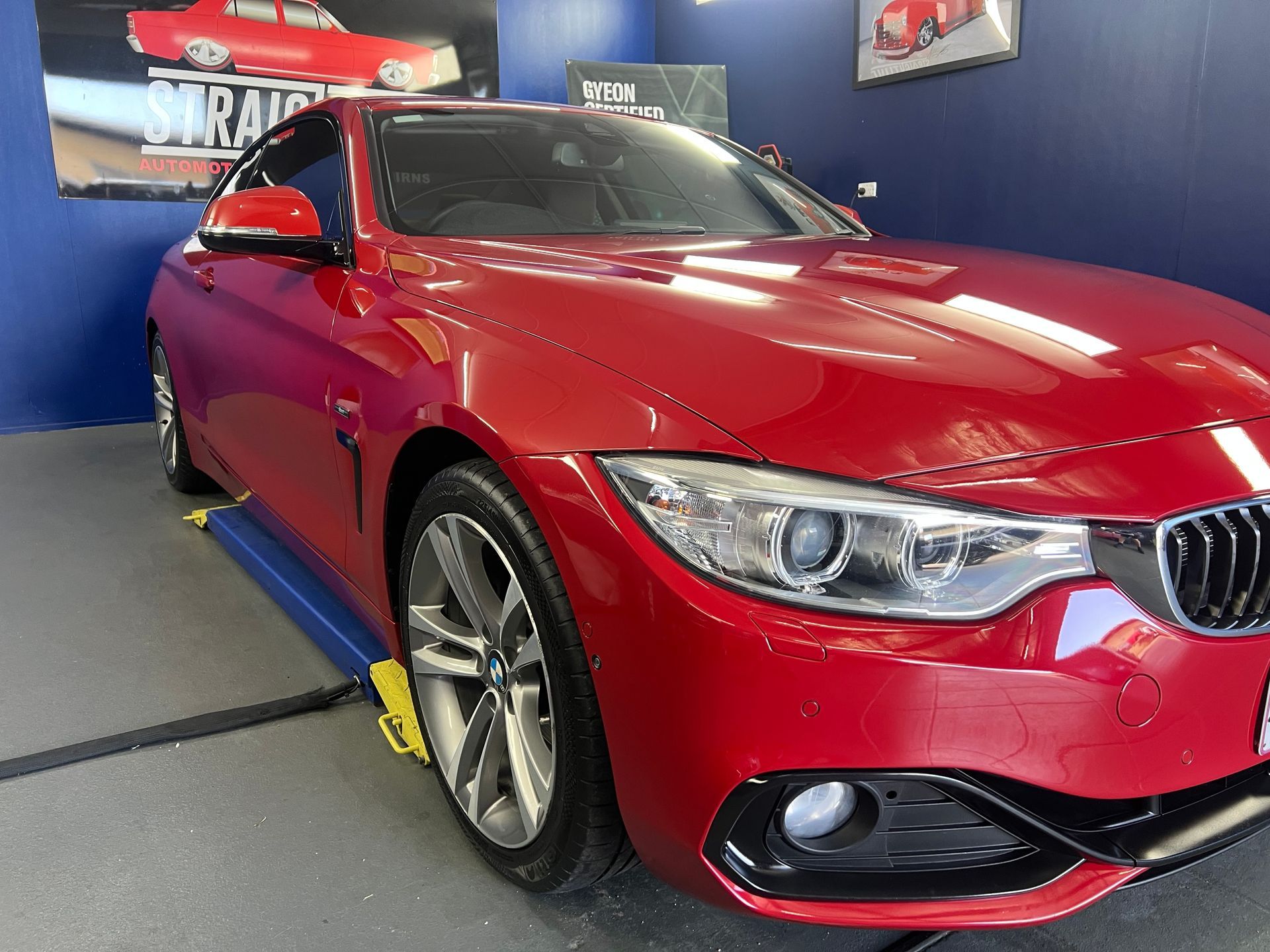 Red BMW Sedan Displayed Indoors on A Showroom Floor — Straightline Detailing Cairns in Bungalow, QLD