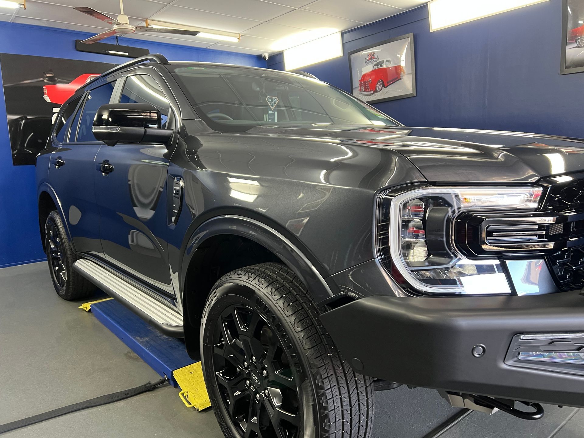 Gray SUV In a Showroom, Lifted on A Ramp — Straightline Detailing Cairns in Bungalow, QLD