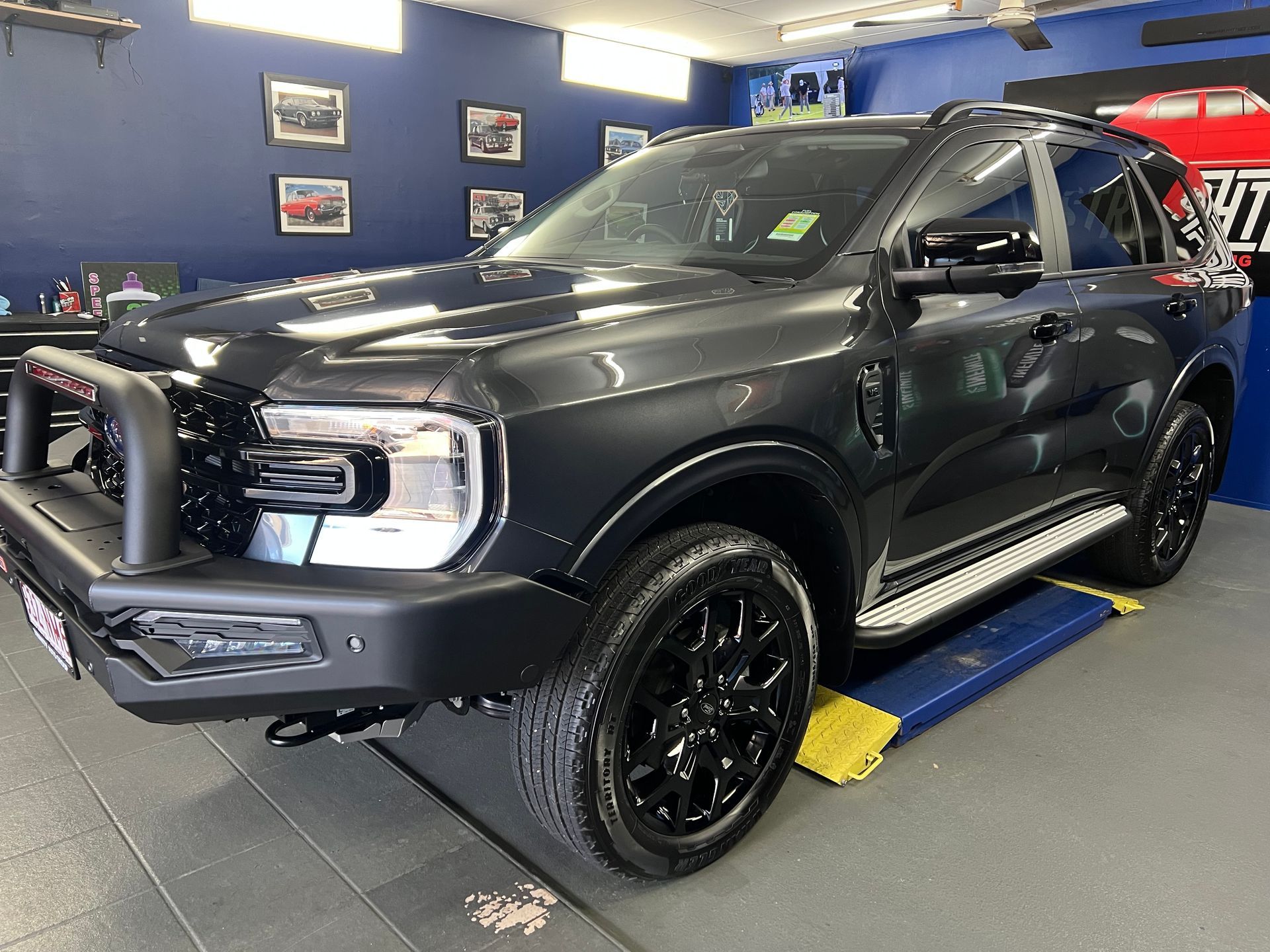 Black SUV In an Auto Shop, Shown on A Lift — Straightline Detailing Cairns in Bungalow, QLD