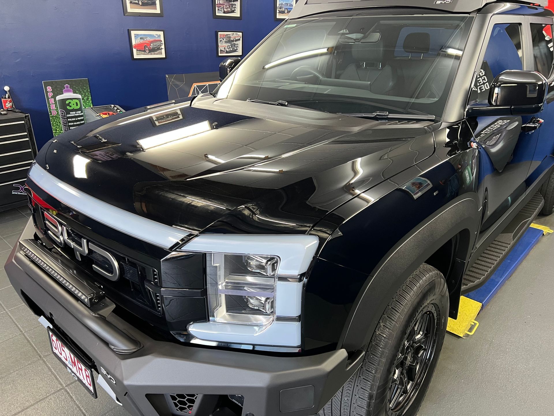 Black Pickup Truck on Display Inside a Showroom — Straightline Detailing Cairns in Bungalow, QLD