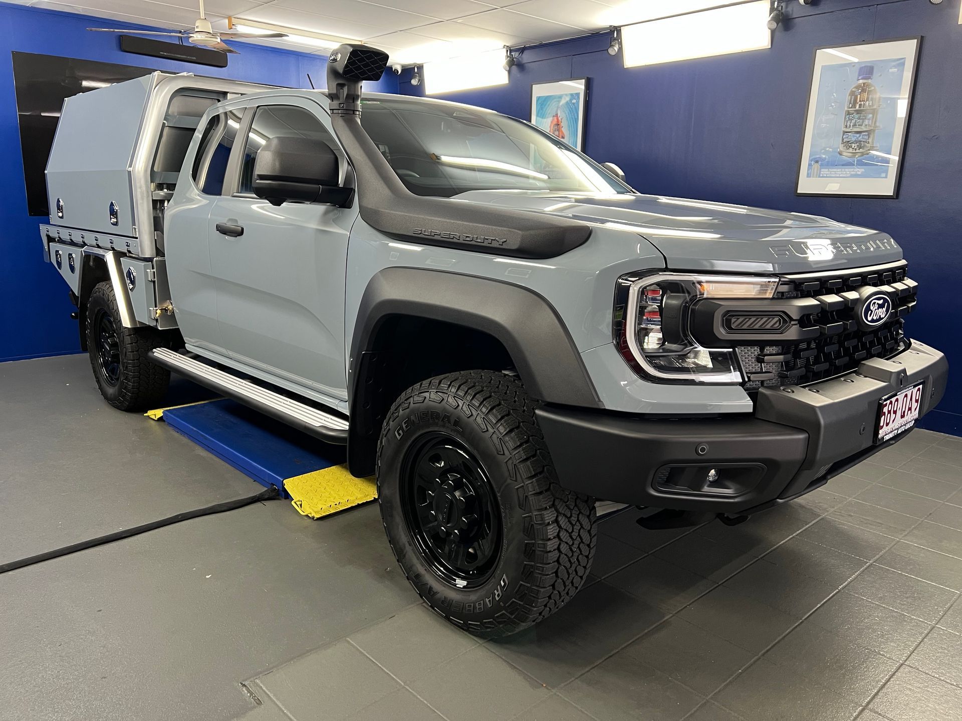 Gray Pickup Truck in A Showroom on A Lift — Straightline Detailing Cairns in Bungalow, QLD