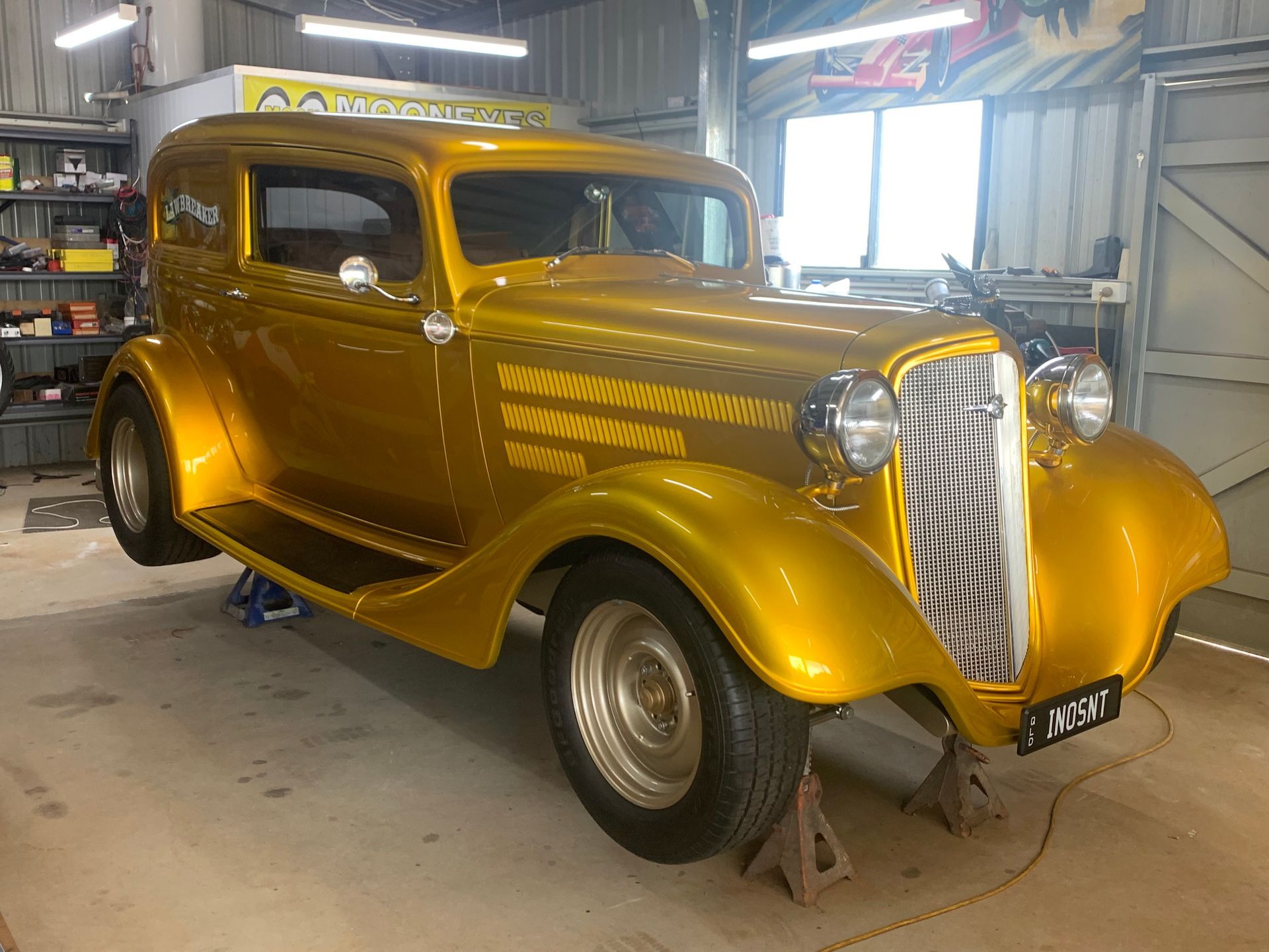 Yellow Vintage Hot Rod Car in A Garage — Straightline Detailing Cairns in Bungalow, QLD