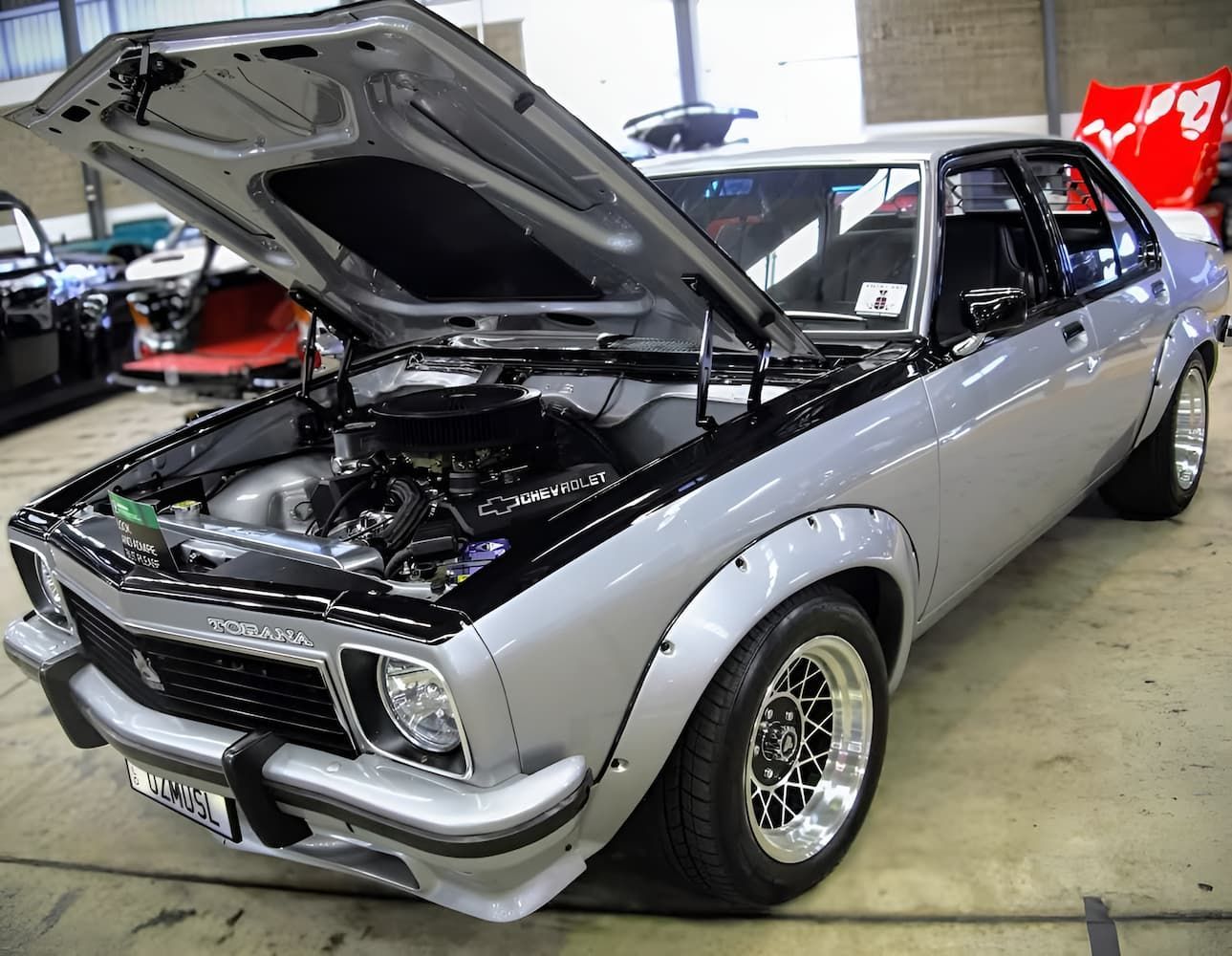 Silver Classic Car with Hood Open at An Indoor Auto Show — Straightline Detailing Cairns in Bungalow, QLD