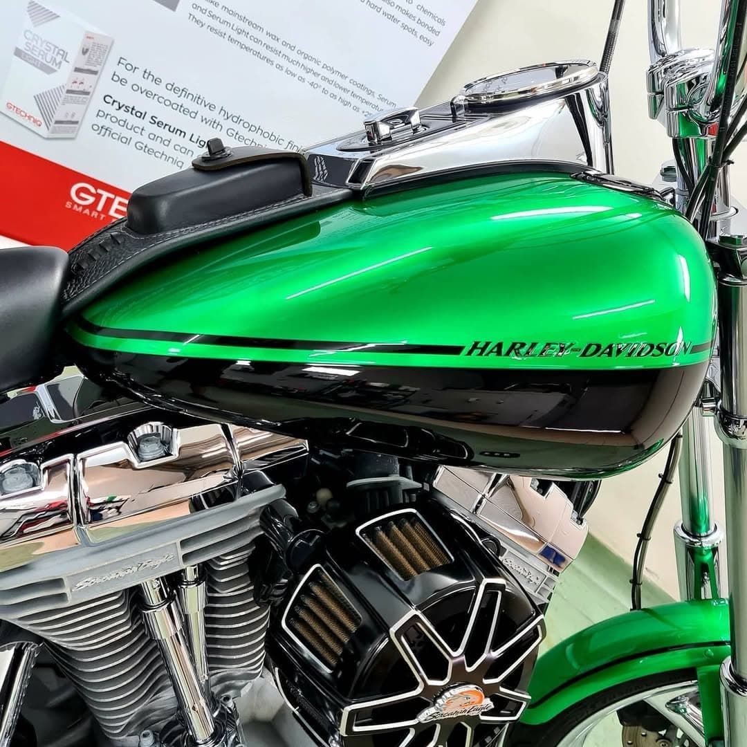 Green Harley-Davidson Motorcycle Fuel Tank and Engine Close-Up at A Showroom — Straightline Detailing Cairns in Bungalow, QLD