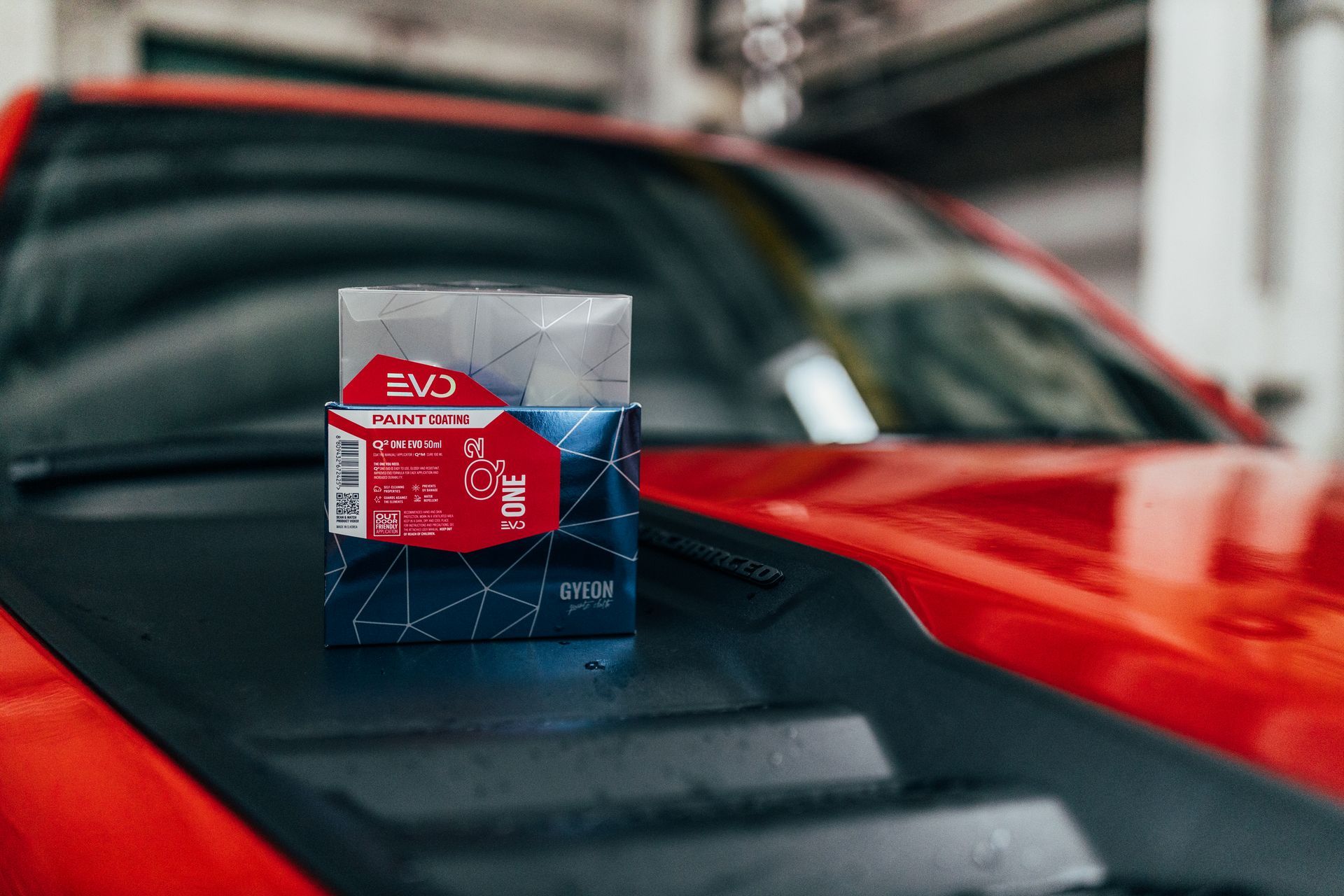Red And Blue EVO Car Care Product on A Black and Red Sports Car Hood — Straightline Detailing Cairns in Bungalow, QLD
