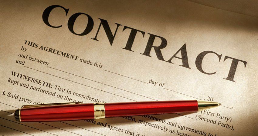 Pen rests on paper that says contract