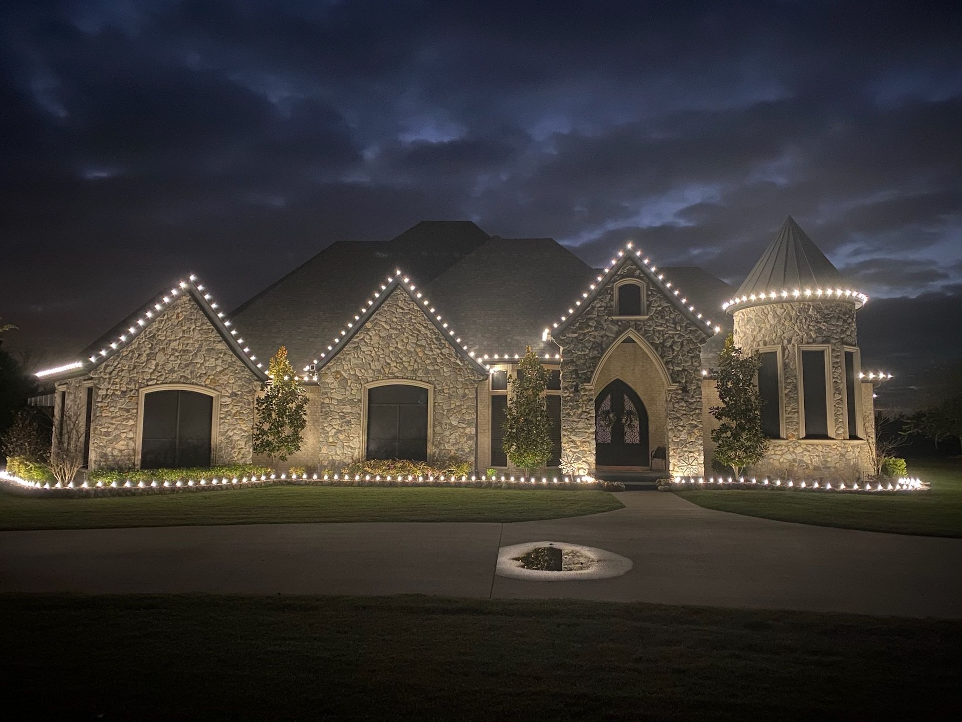 brick house with white christmas lights