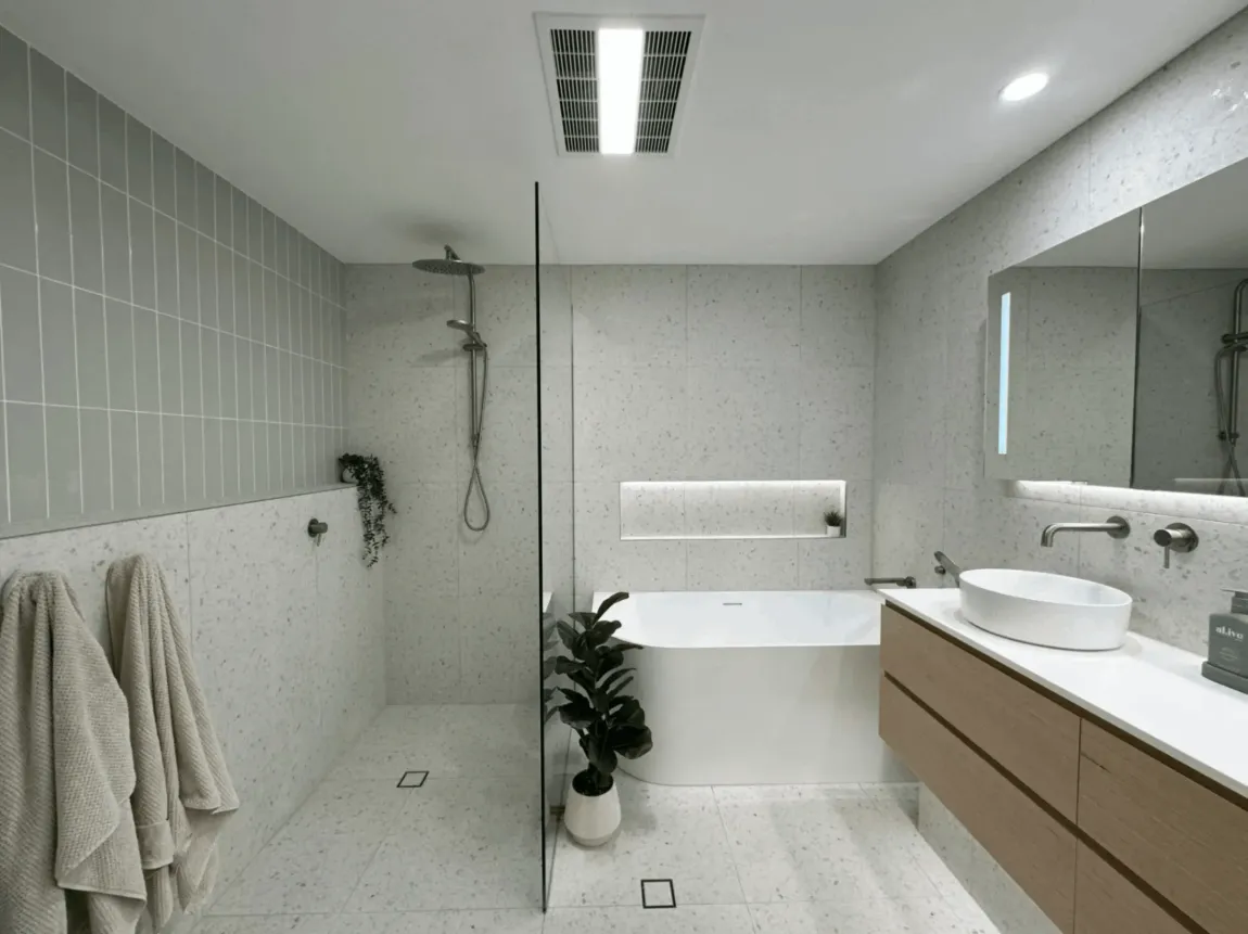 Modern bathroom with shower, bathtub, and vanity. Gray and white colour scheme.