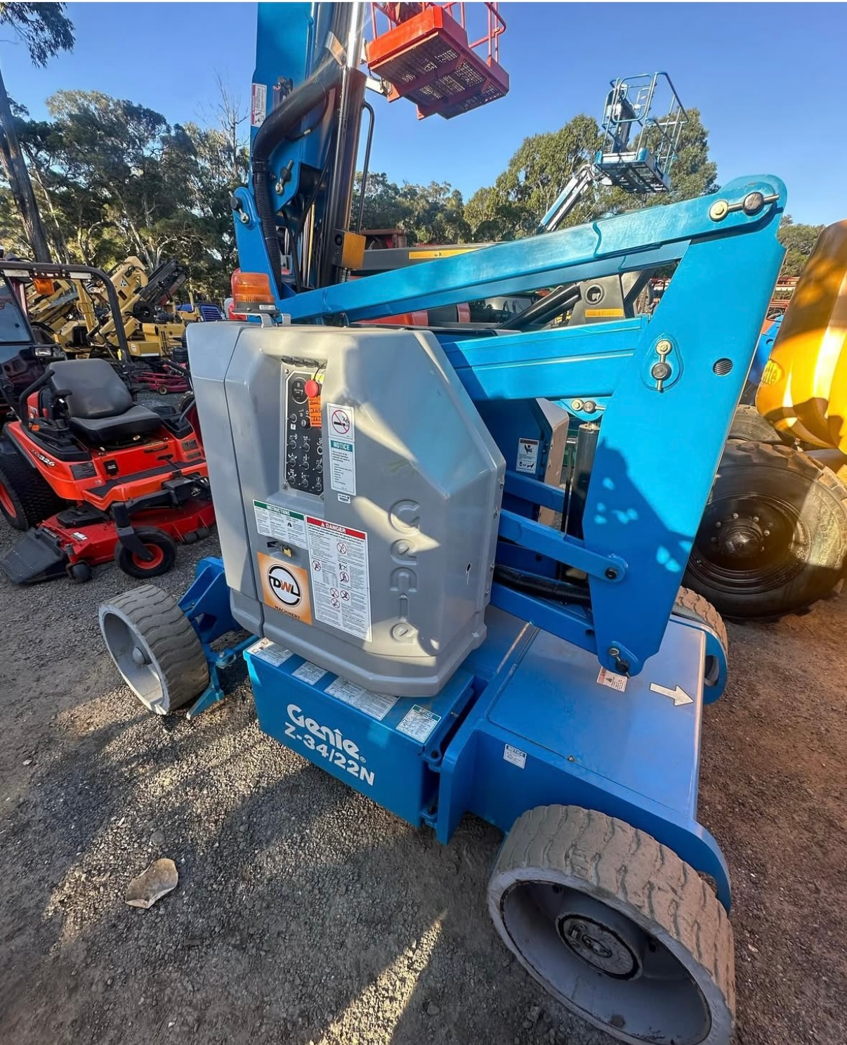 Blue Genie Z-34/22N articulating boom lift in an outdoor equipment yard.