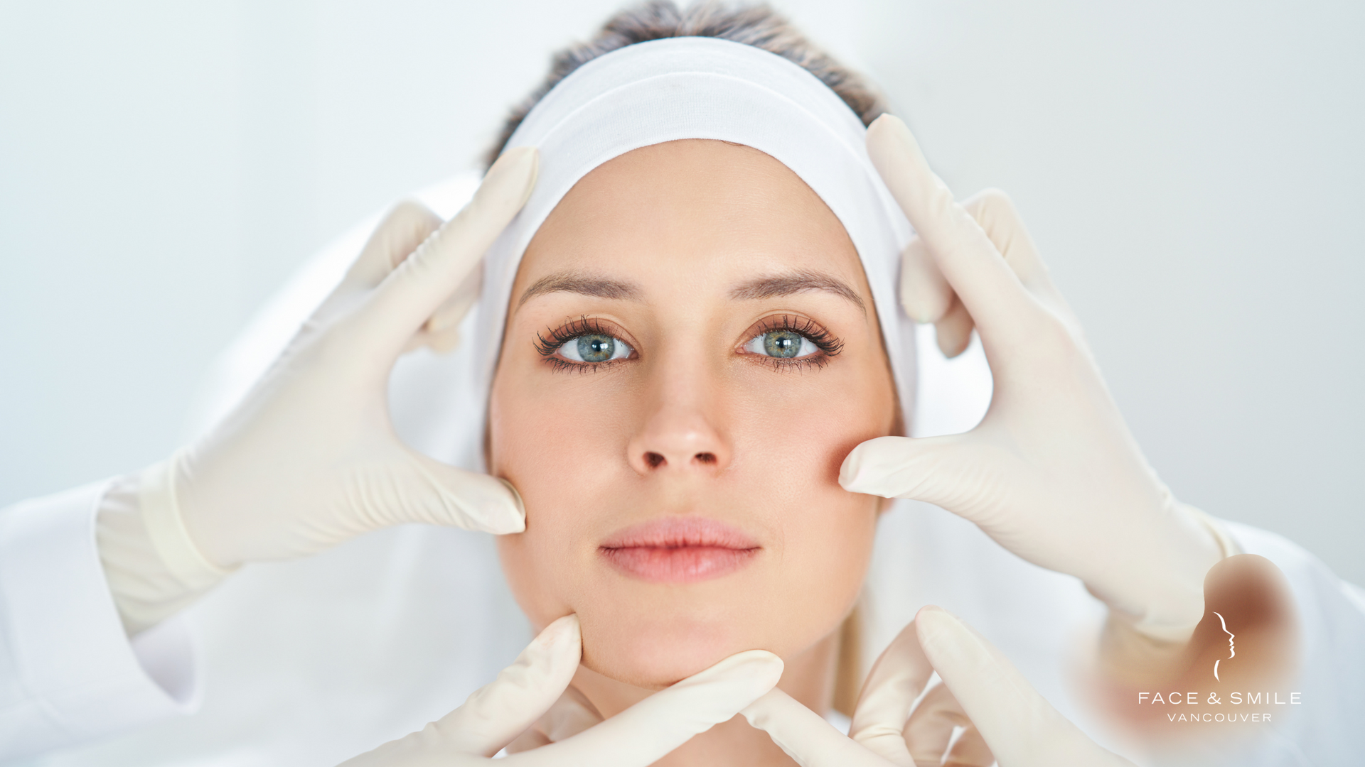 A woman is getting her face examined by a doctor.
