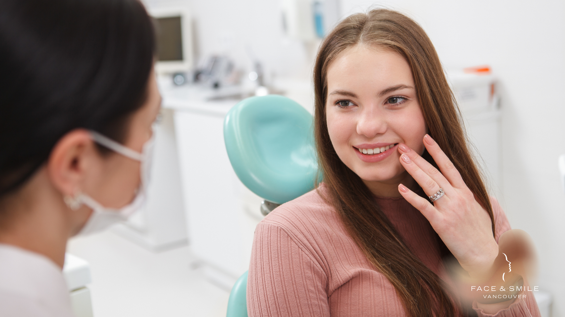 A woman is sitting in a dental chair talking to a dentist.