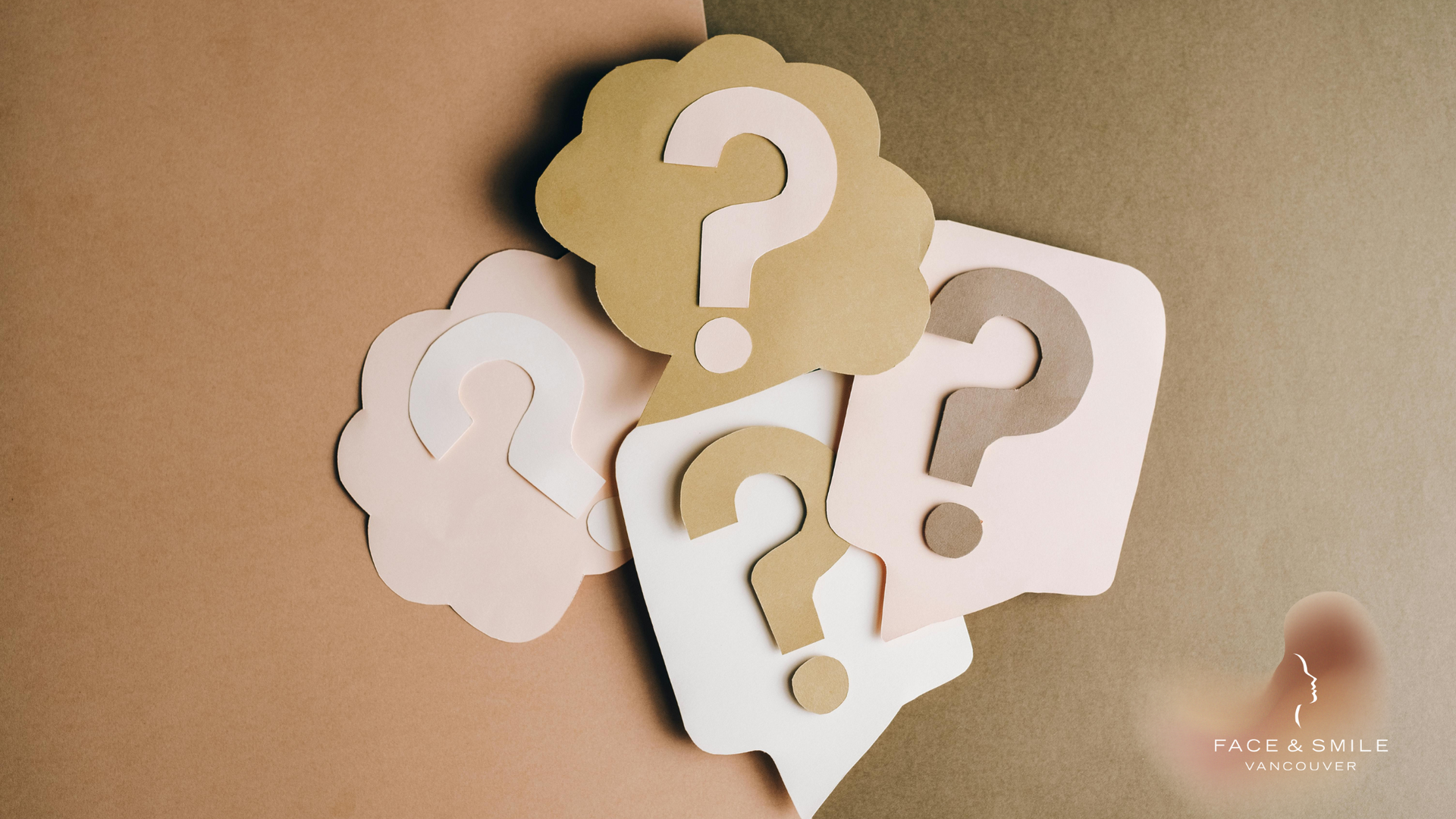 A group of question marks are stacked on top of each other on a table.