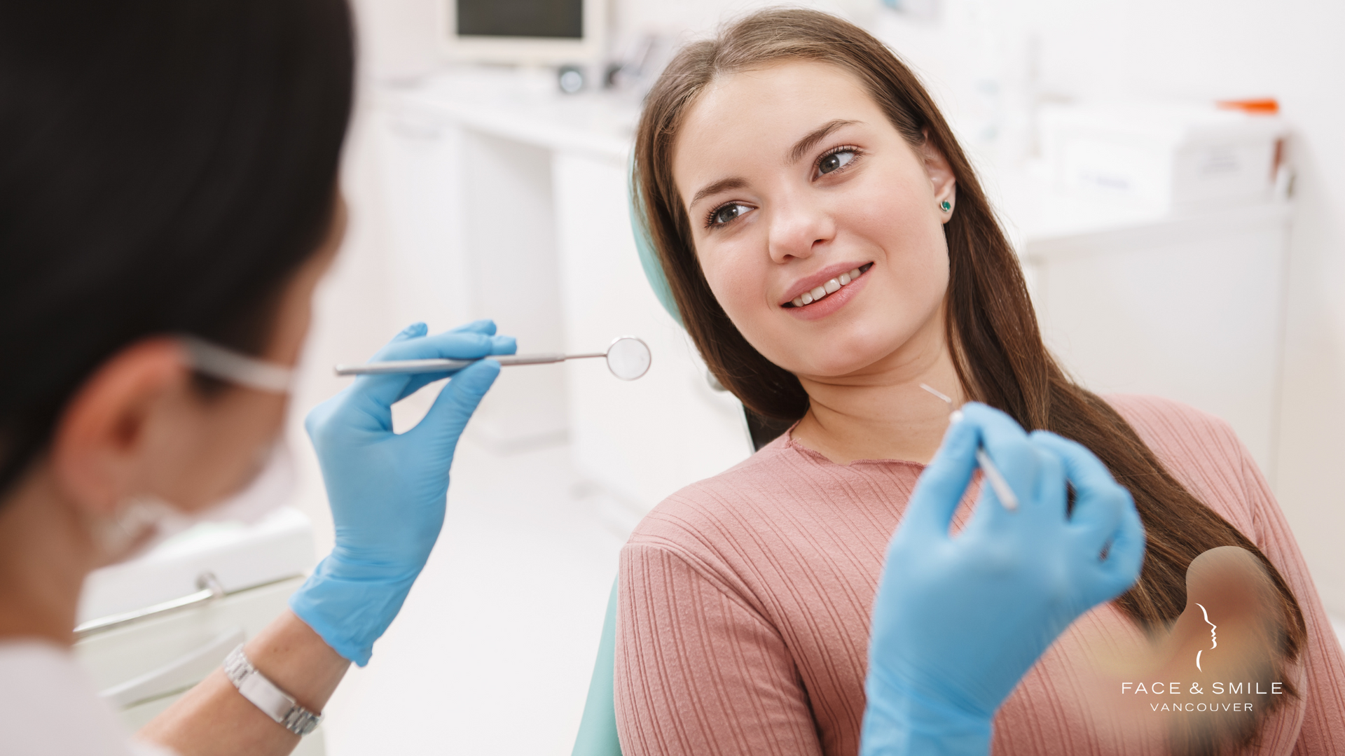 Dentist examining a smiling patient in a dental chair with blue gloves and tools