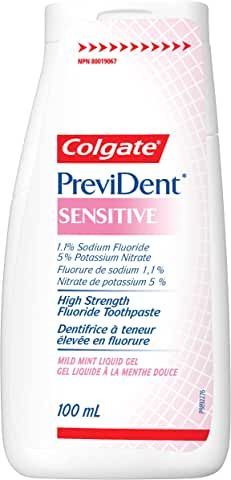 A bottle of colgate provident sensitive toothpaste on a white background.