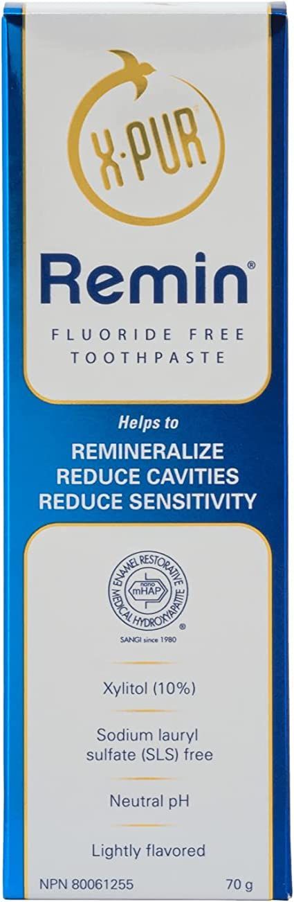 A blue and white box of remin fluoride free toothpaste