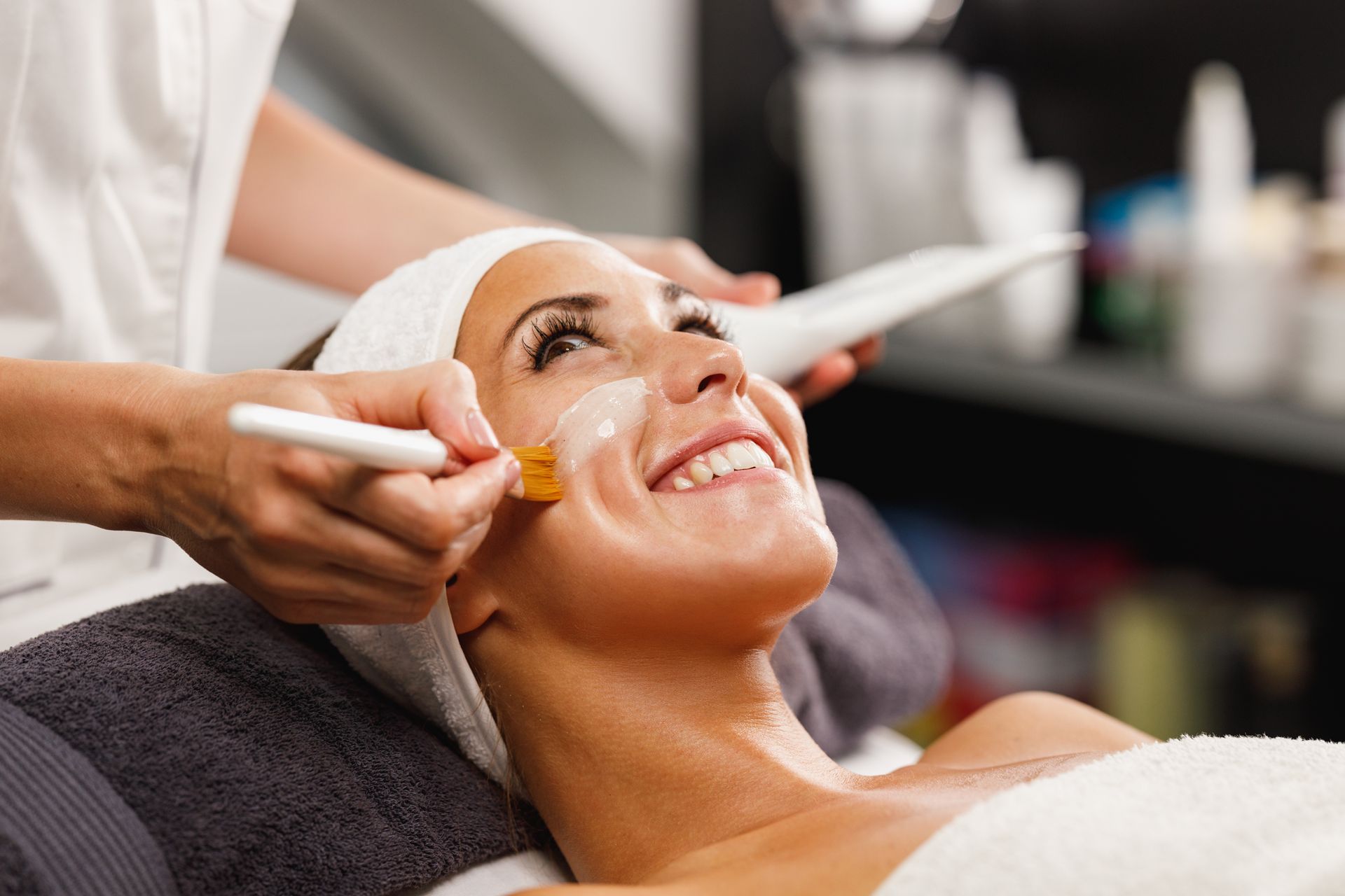 A woman is getting a facial treatment at a spa.