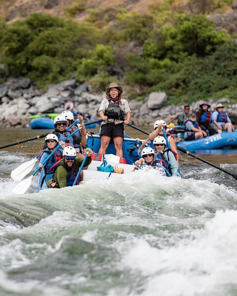 Woman Standing on The Raft with Group of People