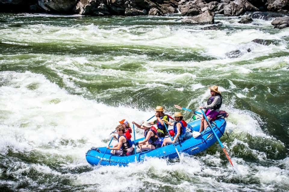 Six People Rafting Down a River
