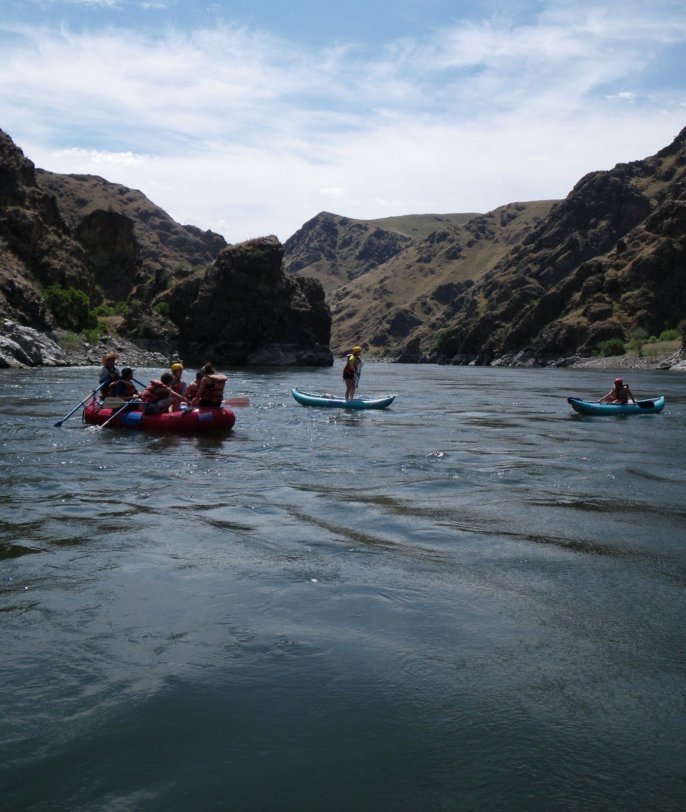 A group of people are floating down a river in kayaks