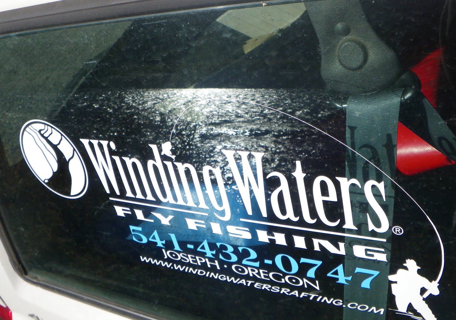 Winding waters fly fishing is advertised on the side of a vehicle