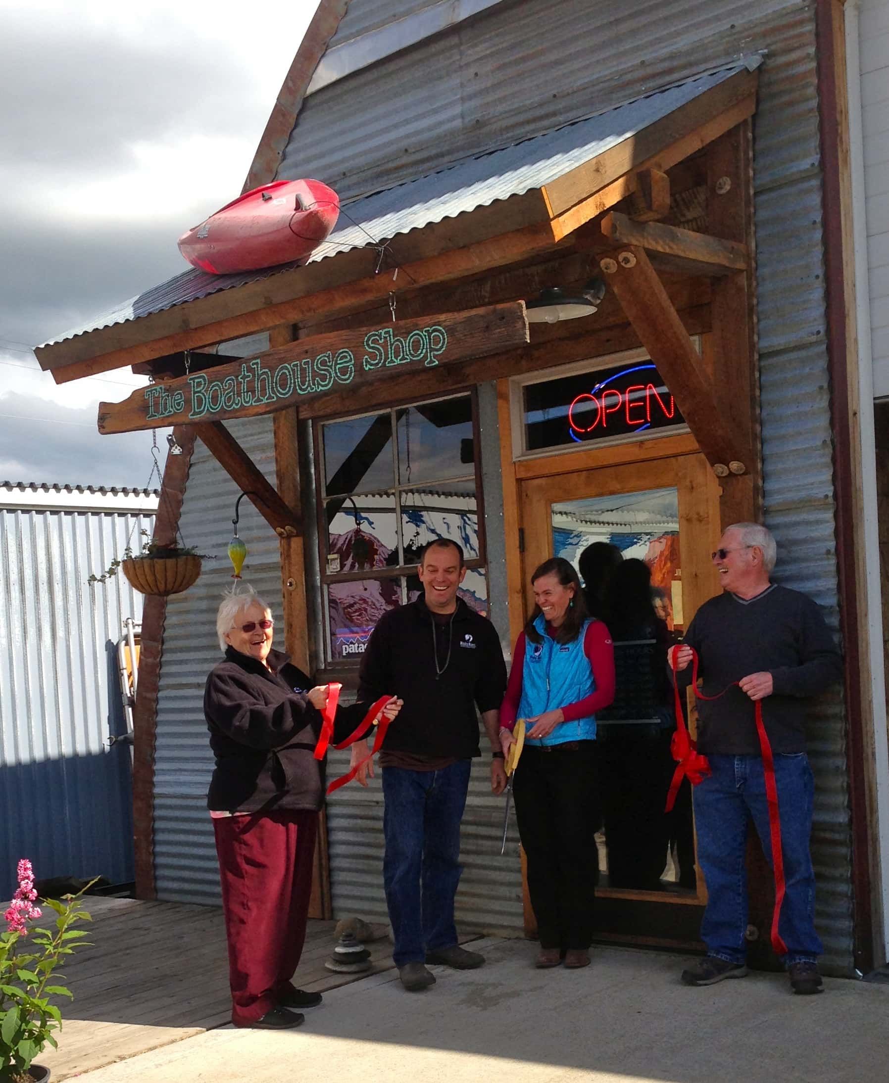 A group of people standing in front of a building with a sign that says ' ice cream ' on it