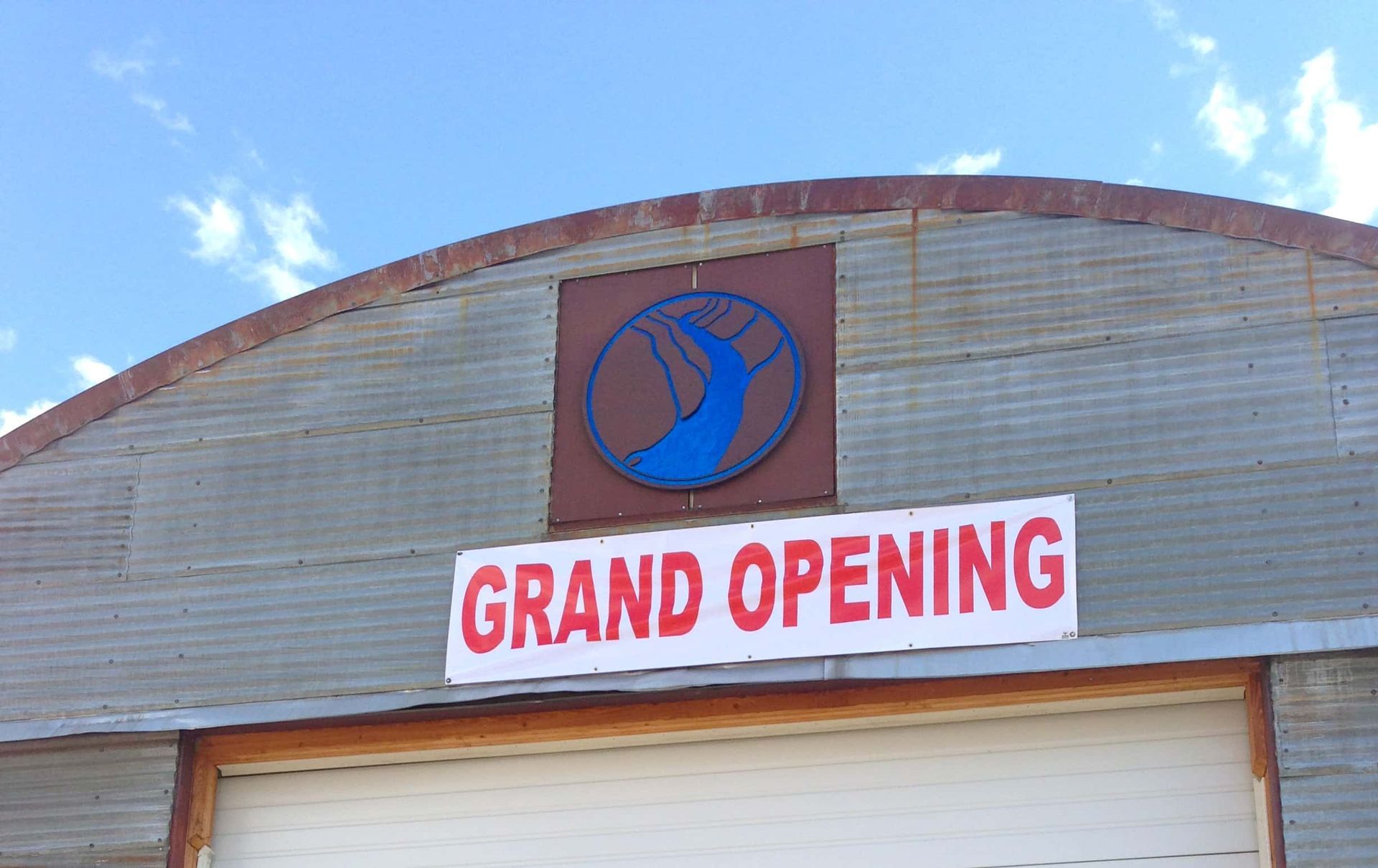 A building with a sign that says grand opening