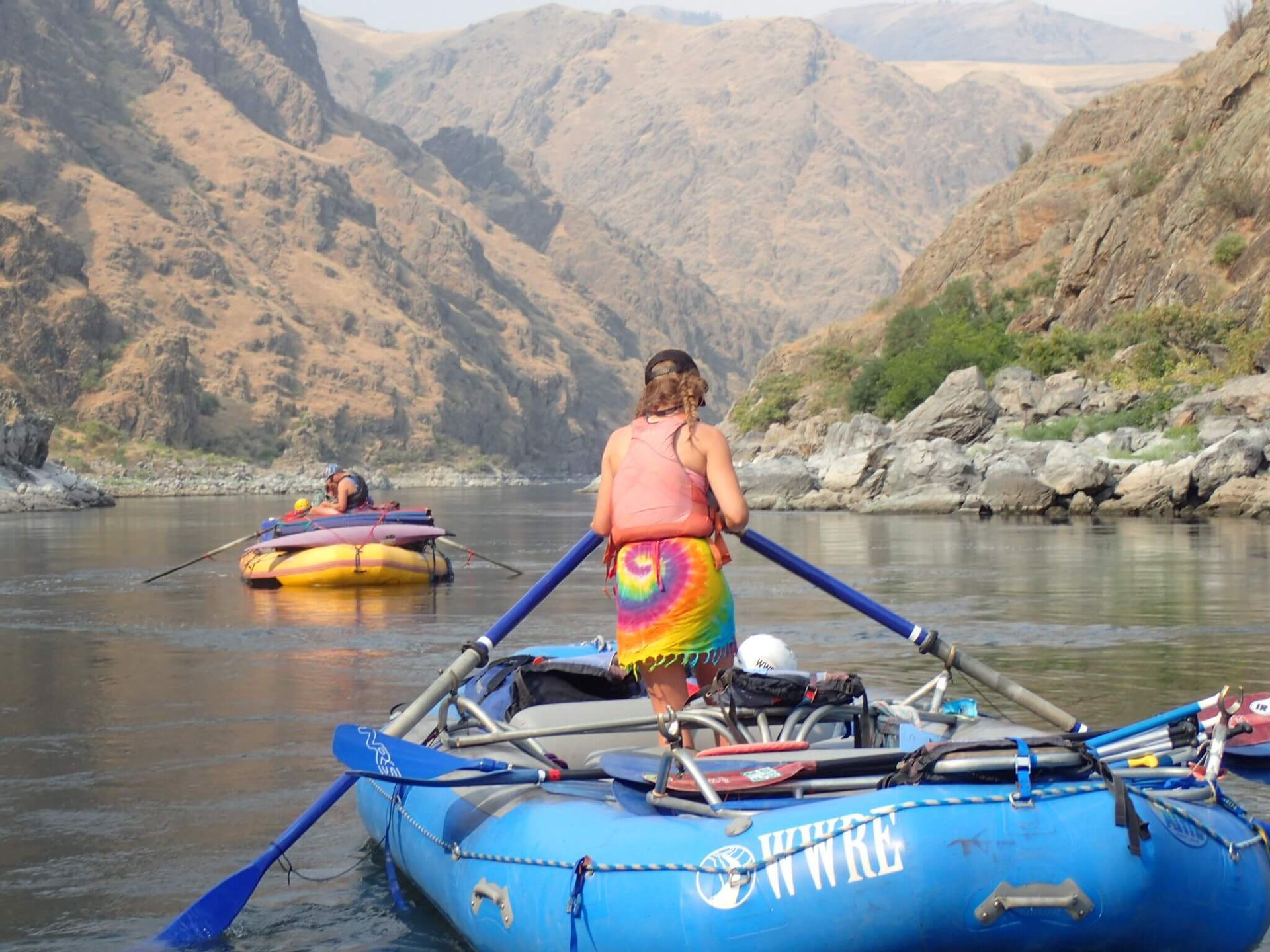 Woman in A Pink Tank Top Is Standing in A Blue Raft on A River