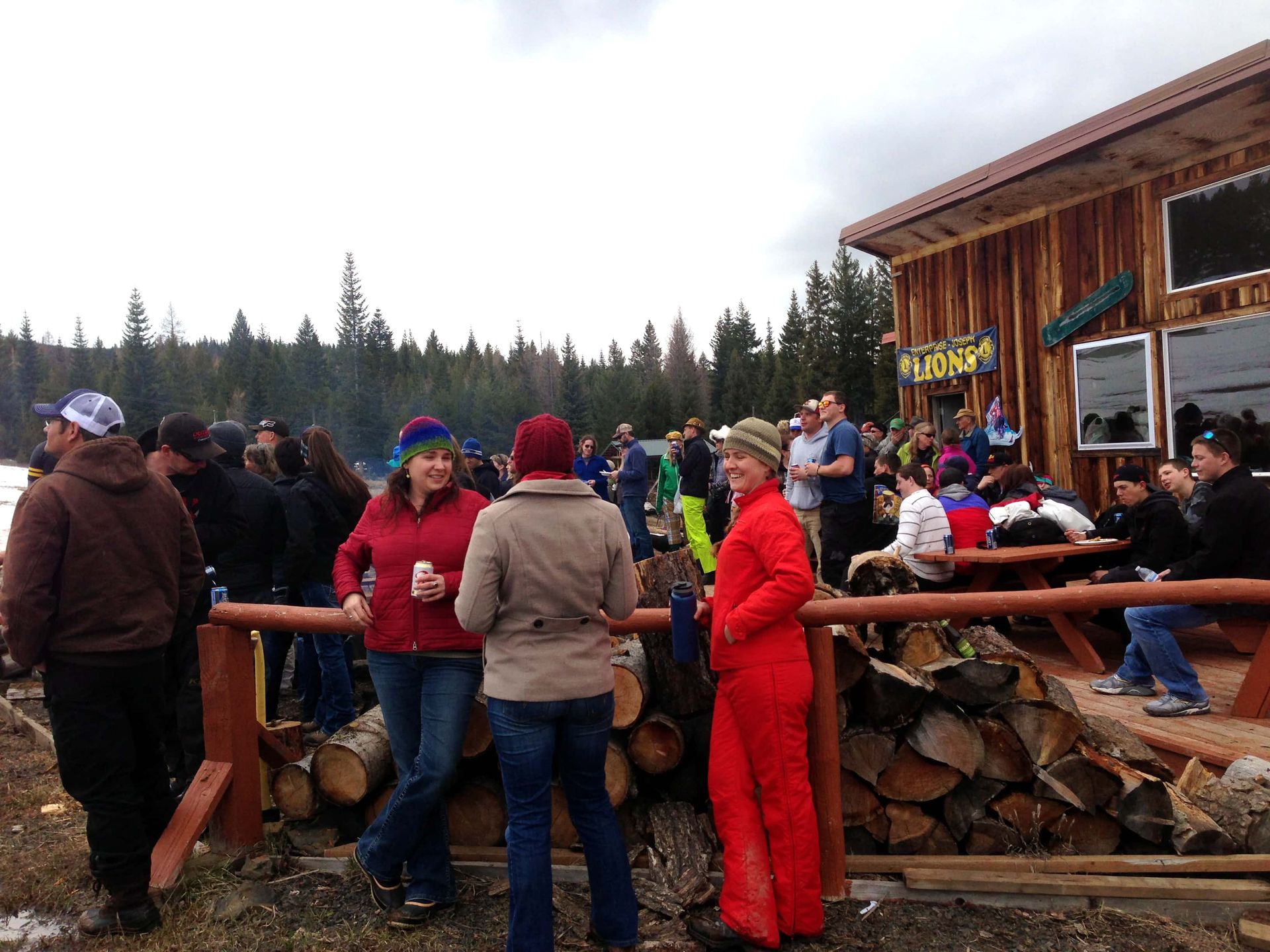 A group of people standing outside of a building with a sign that says lodge