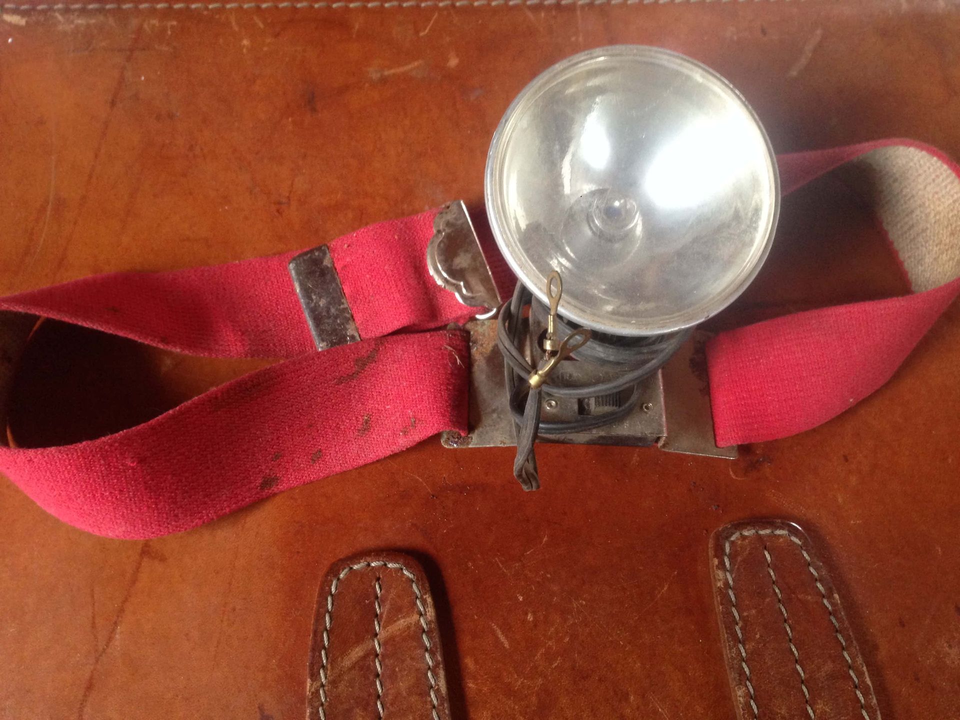 A red belt with a light attached to it