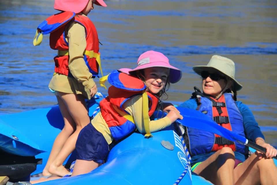 Woman and Two Children in Blue Raft
