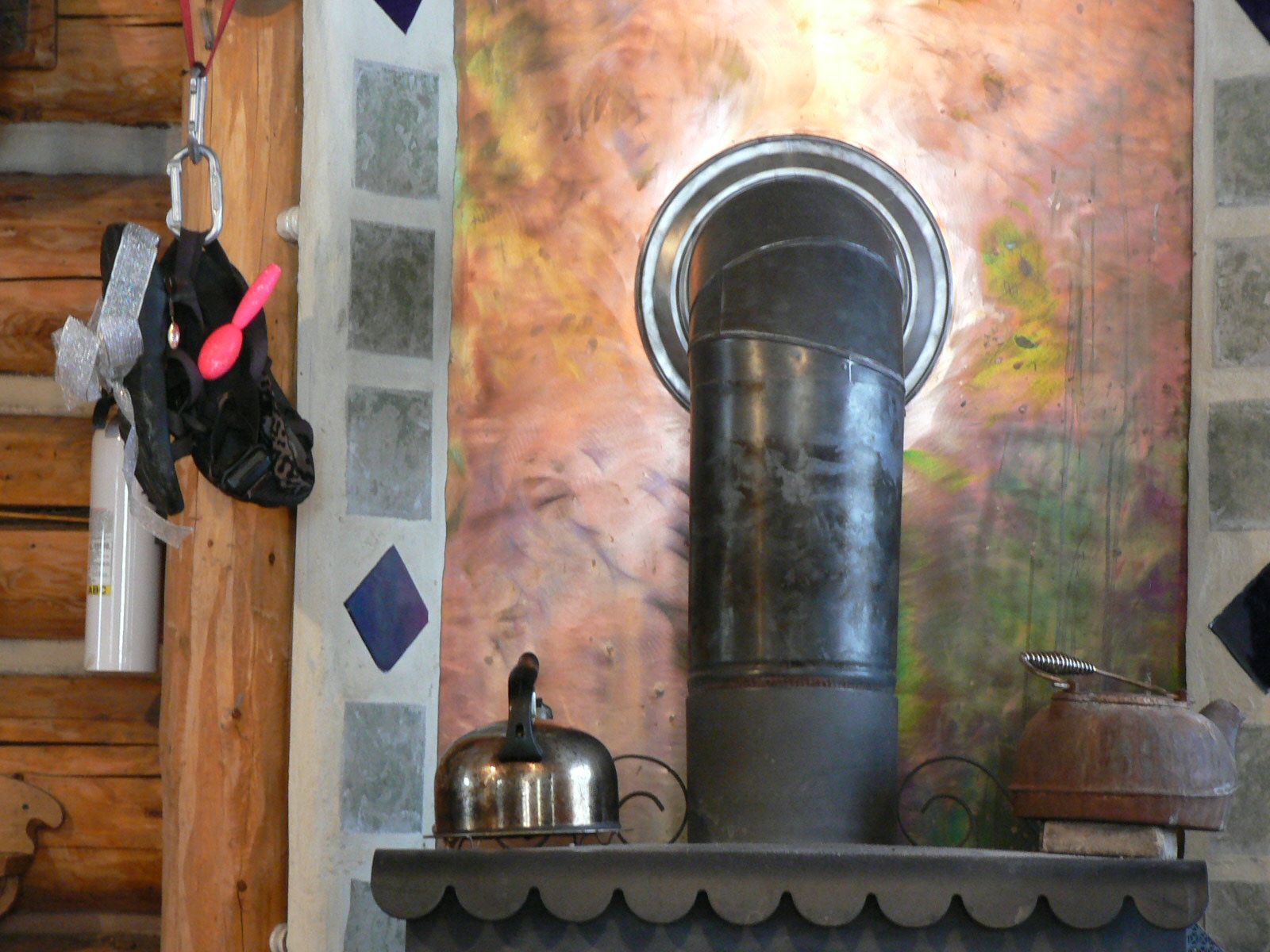 A fireplace with a chimney and a kettle on it
