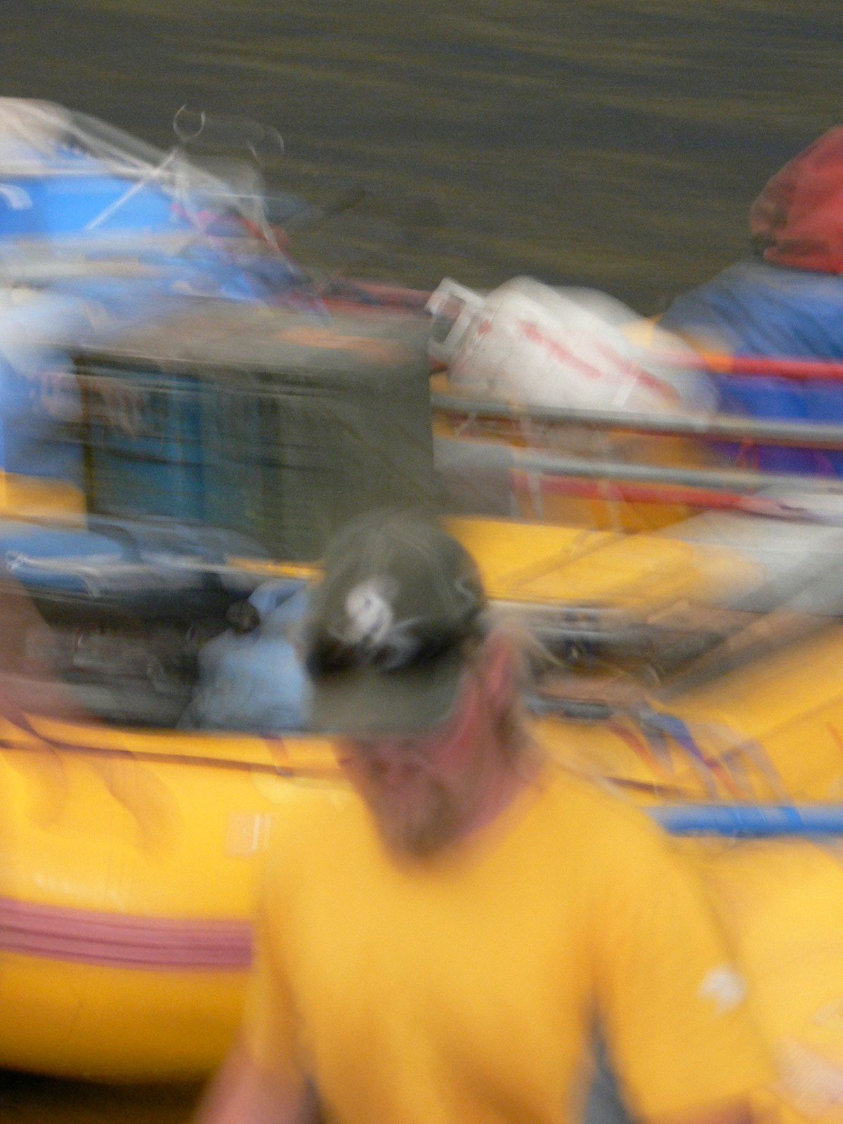 A blurry picture of a man in a yellow shirt