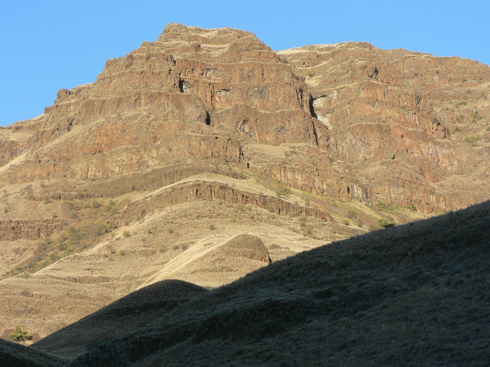 A mountain with a blue sky in the background