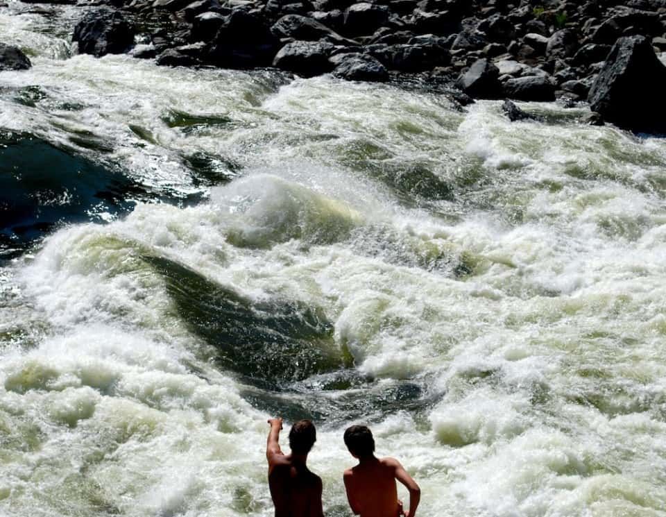 Two People Are Standing in the Middle of A River