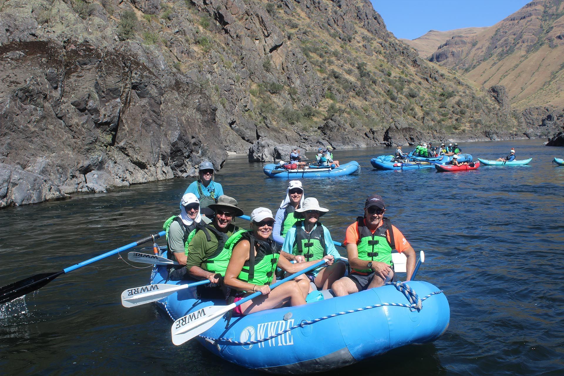 A group of people are in a raft on a river.