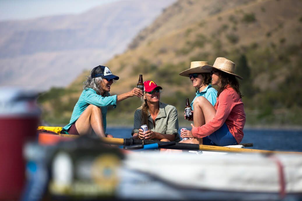 Group of Women Are Sitting in A Boat on A River
