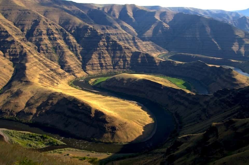 A river flowing through a canyon surrounded by mountains