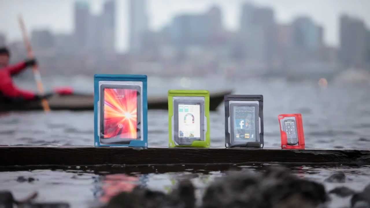 A group of cell phones are sitting on a dock in the water.